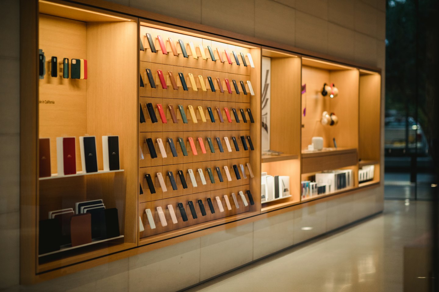 Retail wall display with organized phone cases and electronic accessories.